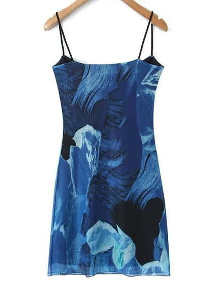 Blue mini cami dress with floral pattern on a hanger against a white background