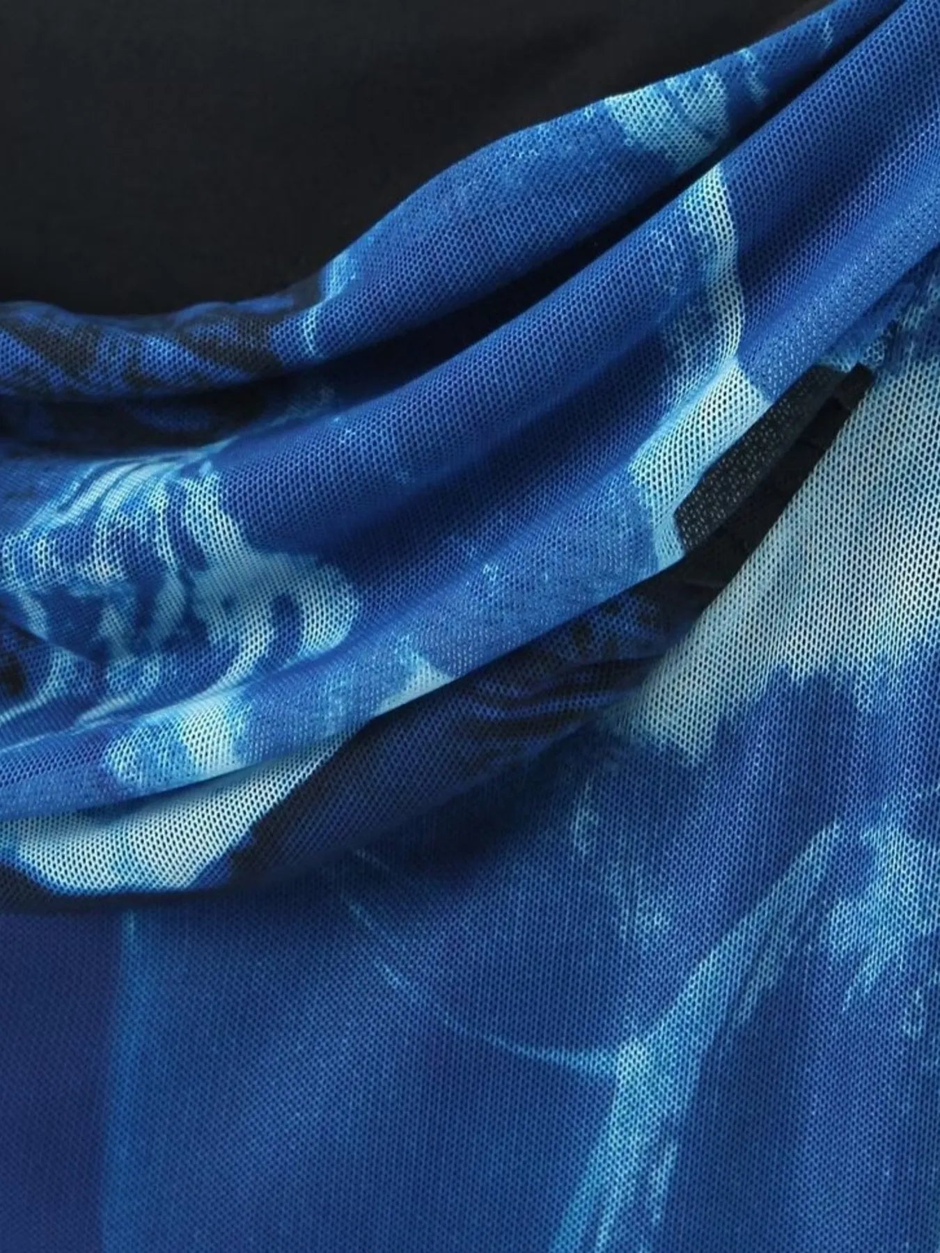 Close-up of blue fabric with floral pattern of mini cami dress