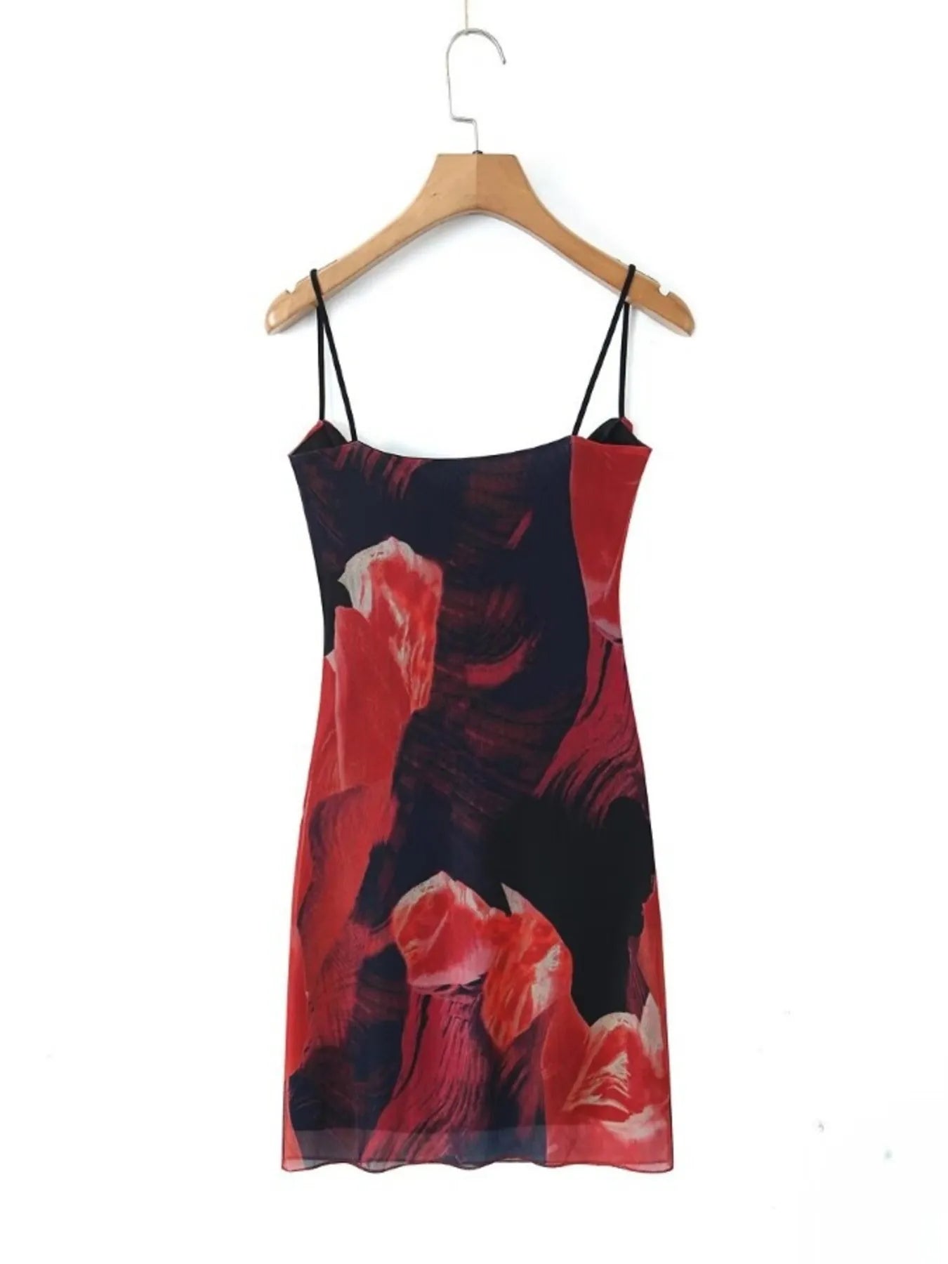 Mini Cami Dress with floral design on a hanger against a white background