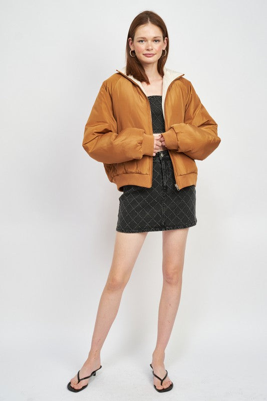 woman wearing a high quality reversible insulated puffer jacket with zipper front closure 