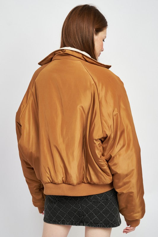 back view of woman wearing reversible puffer jacket for fall/winter outerwear