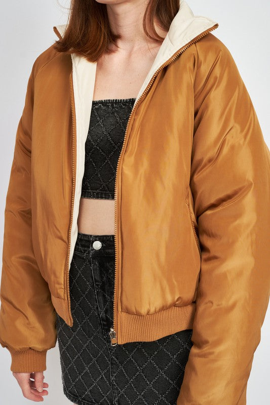 close up view of brown/ivory reversible puffer jacket for women 