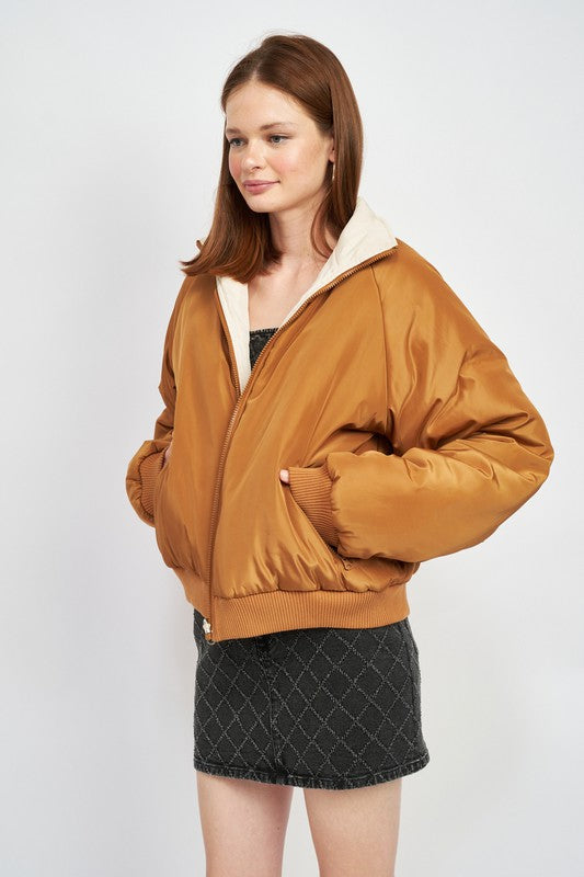 model posing in a brown/ivory reversible puffer winter jacket for women 