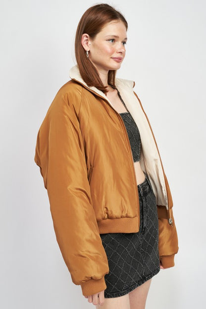 woman wearing a minimalist reversible puffer jacket side view
