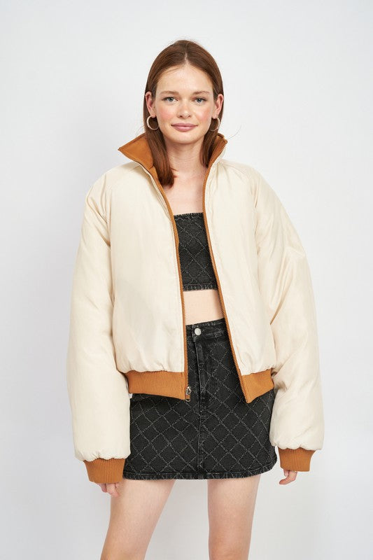 woman wearing a two tone reversible puffer jacket for fall/winter wear 