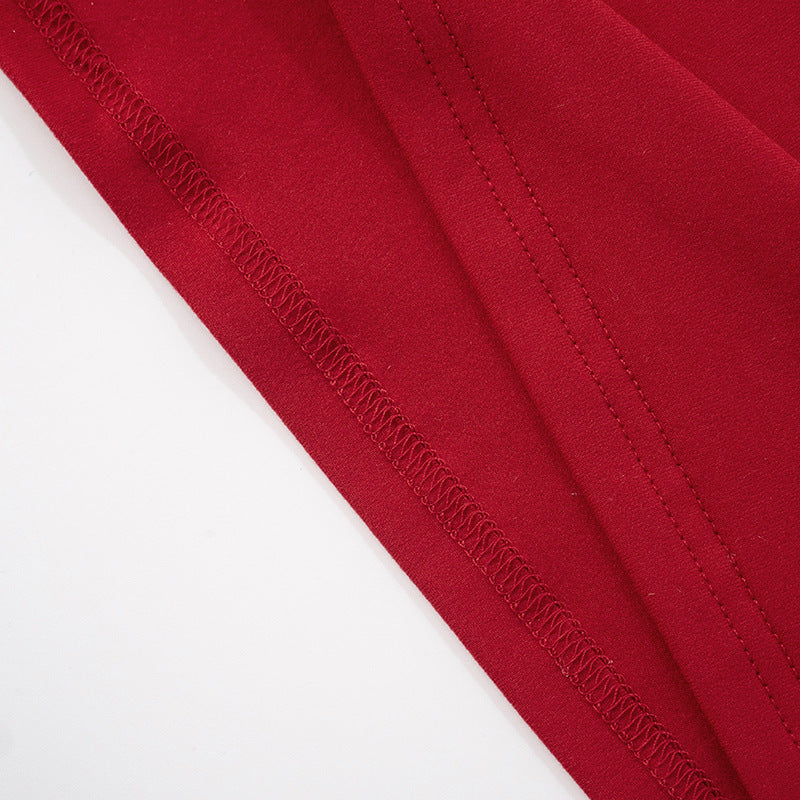 Close-up of red fabric with a visible seam stitching for red sleeveless cutout maxi dress on a white background