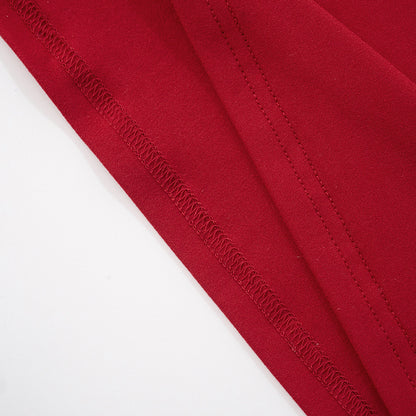 Close-up of red fabric with a visible seam stitching for red sleeveless cutout maxi dress on a white background