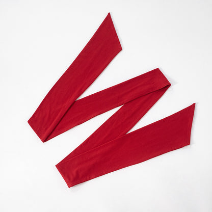 Red ribbon for hollow out red maxi evening dress arranged on a white background