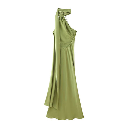 Back view of a A-line green halter ribbon dress showing back drape, buttons on back of neck and open back detail