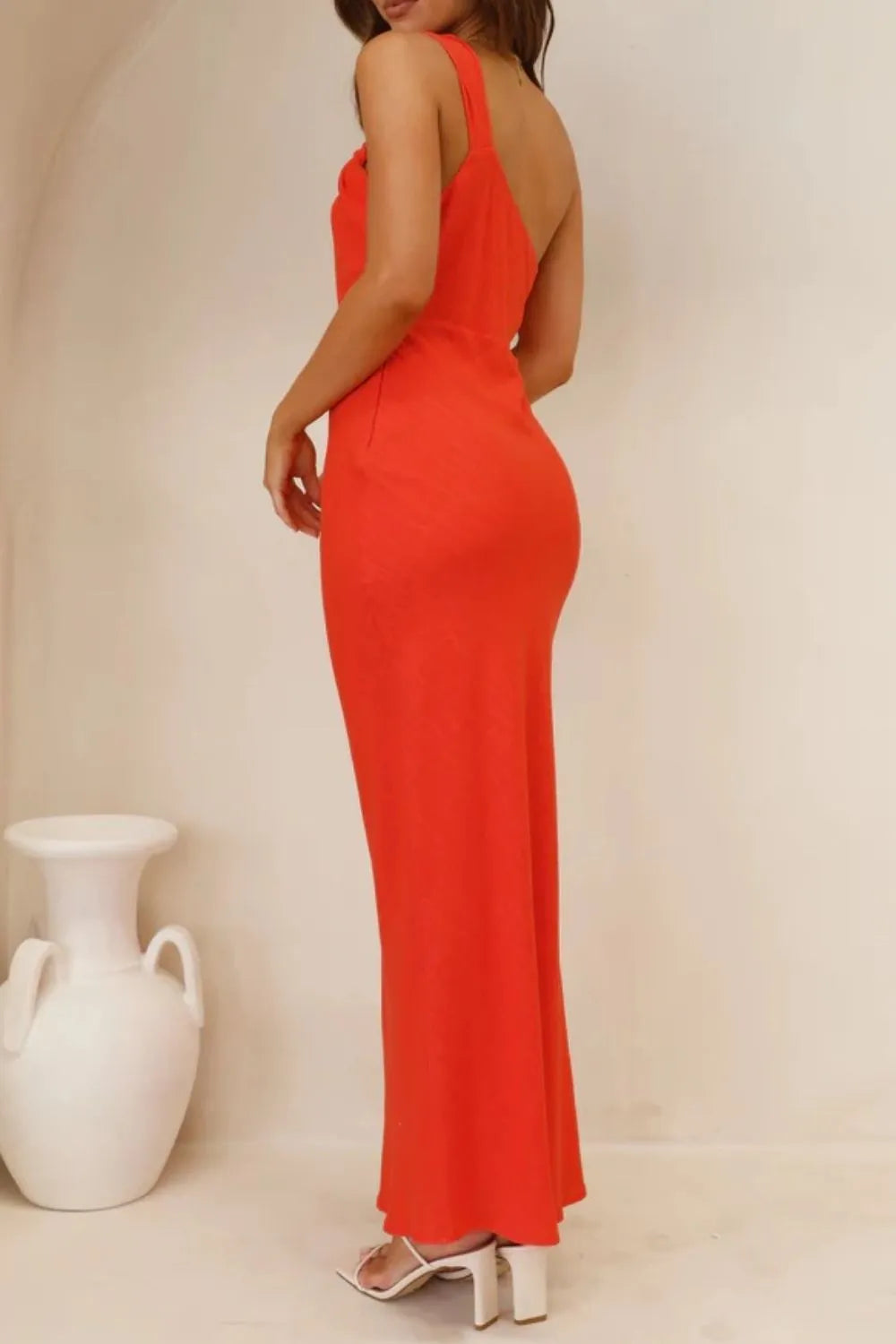 Model wearing  one-shoulder maxi dress rear view 