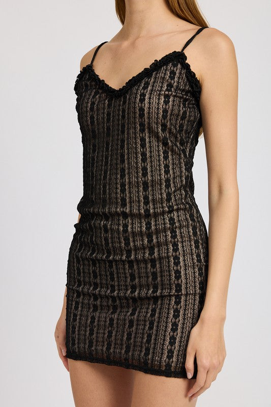 Black patterned lace ruffle mini dress worn by a model on a white background close up side view