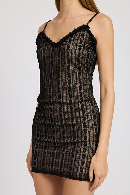Black patterned lace ruffle mini dress worn by a model on a white background close up side view