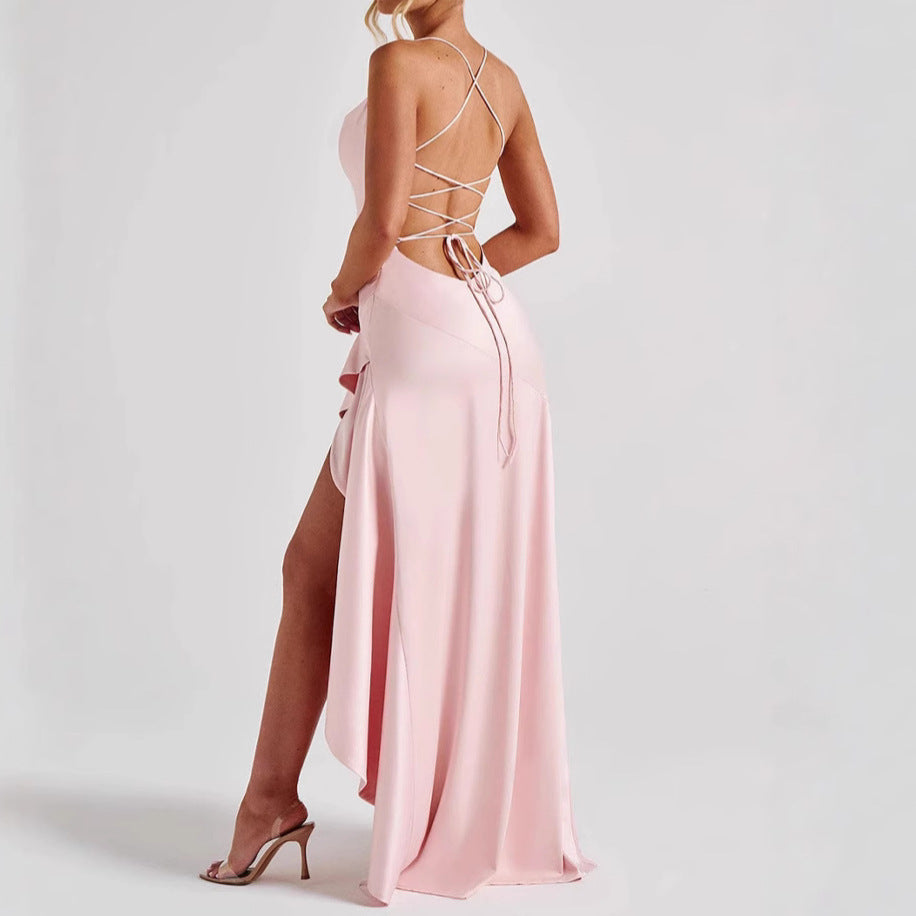 Pink backless maxi summer dress with open back and high slit on a white background