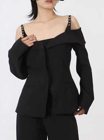 Woman wearing a black luxury designer inspired fashion cold-shoulder blazer/jacket with edgy statement buckle strap  on a white background