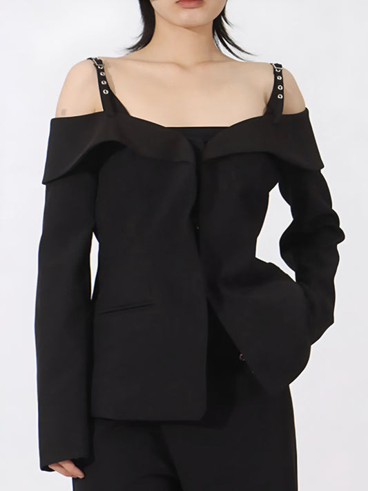 Black off-shoulder ruffled blazer for edgy streetwear fashion worn by a woman on a white background