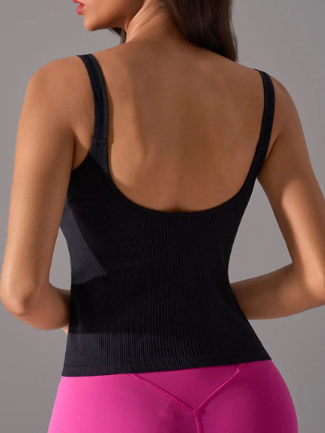 Women's scoop neck active tank top in Black on model back view