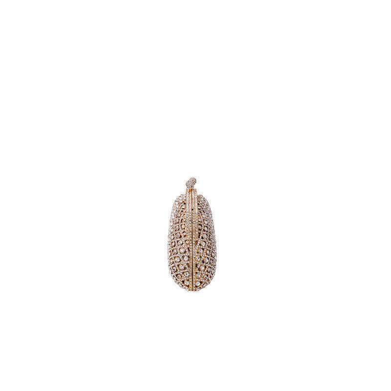 Elegant gold clutch with structured design and clasp top side view on white background