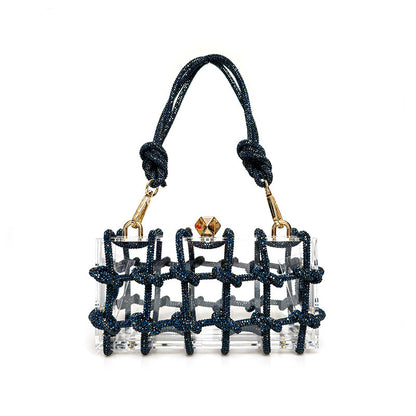 A shiny rhinestone-encrusted blue acrylic handbag in a square shape with a single handle and gold-colored hardware.