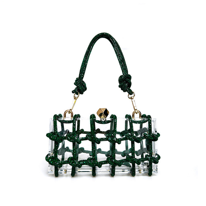 A shiny rhinestone-encrusted dark green acrylic handbag in a square shape with a single handle and gold-colored hardware.