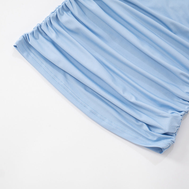 Light blue mesh one shoulder top hem close up on a white background