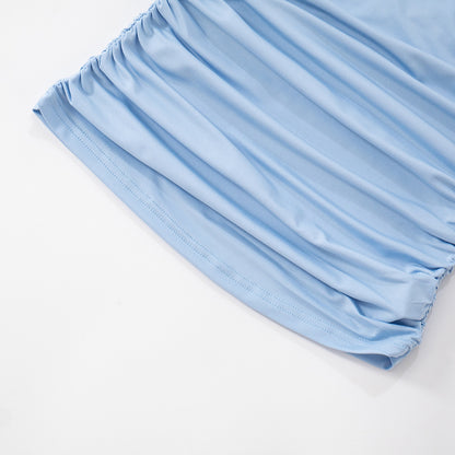 Light blue mesh one shoulder top hem close up on a white background