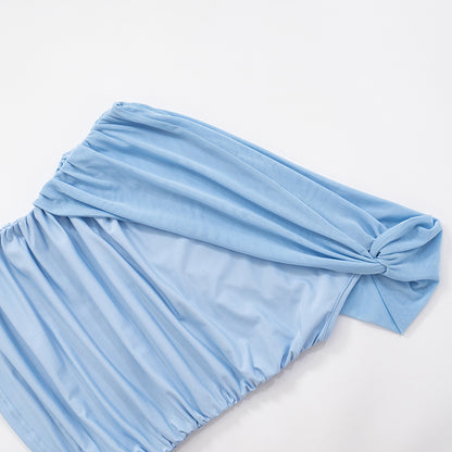 Light blue mesh one shoulder top with a knot laying flat on a white background