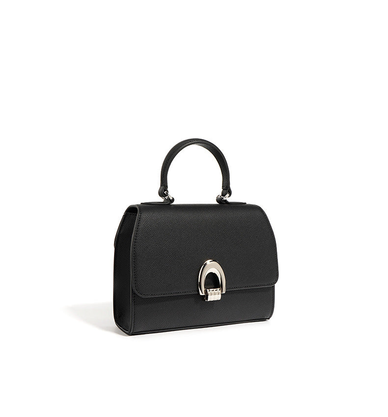 A black genuine leather handbag with a shell shape,  featuring a sandwich pocket design and a single shoulder strap.