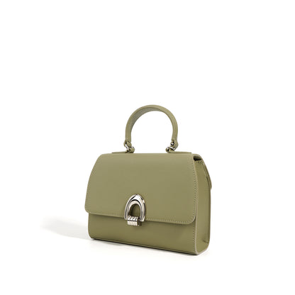 A green colored handbag with a shell shape, made from genuine leather, featuring a sandwich pocket design and a single shoulder strap.