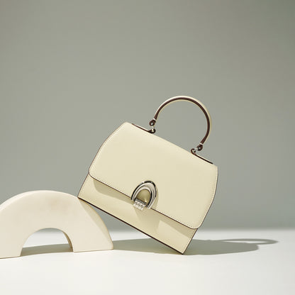 white/ivory genuine leather simple urban style bag  on a grayish background
