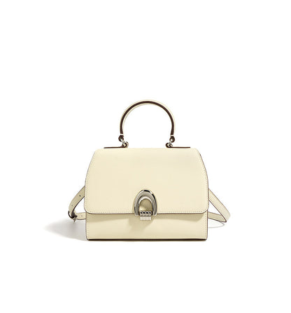 A ivory/white minimalist real leather handbag with handle on a white background