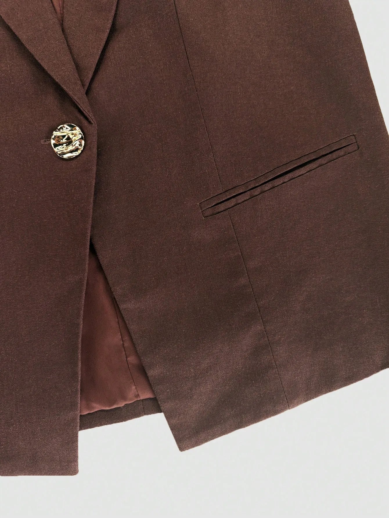 Brown blazer with a button  for two piece co-ord pant set on a white gray background