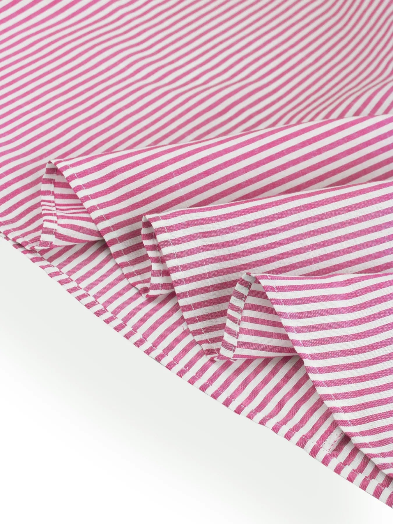 Close up view of hem of pink casual striped midi summer dress
