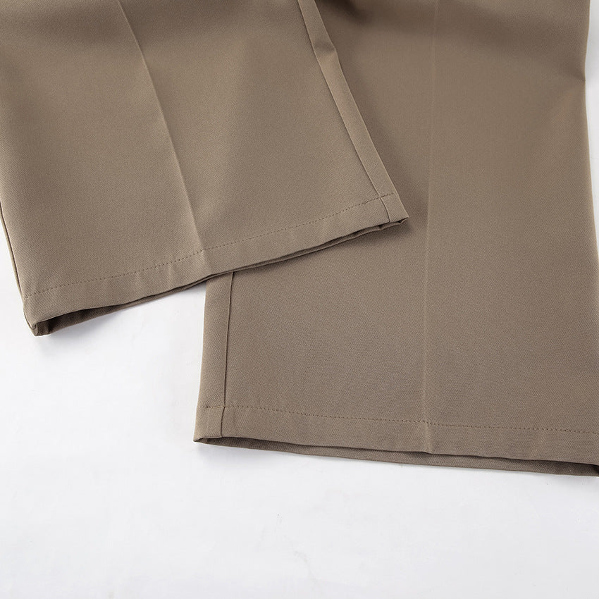 Close up of pants leg for tailored two piece vest and high waist pant set in brown fabric on a white background