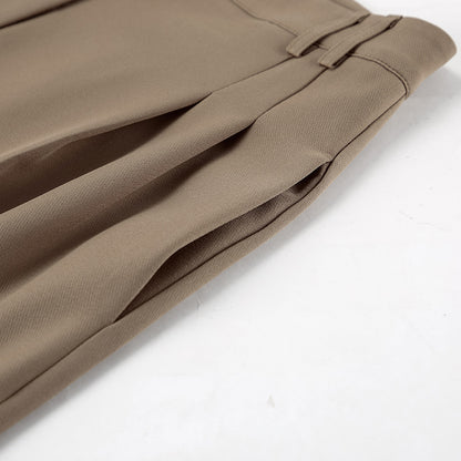Close-up of side pockets for brown pants suit set on a white background