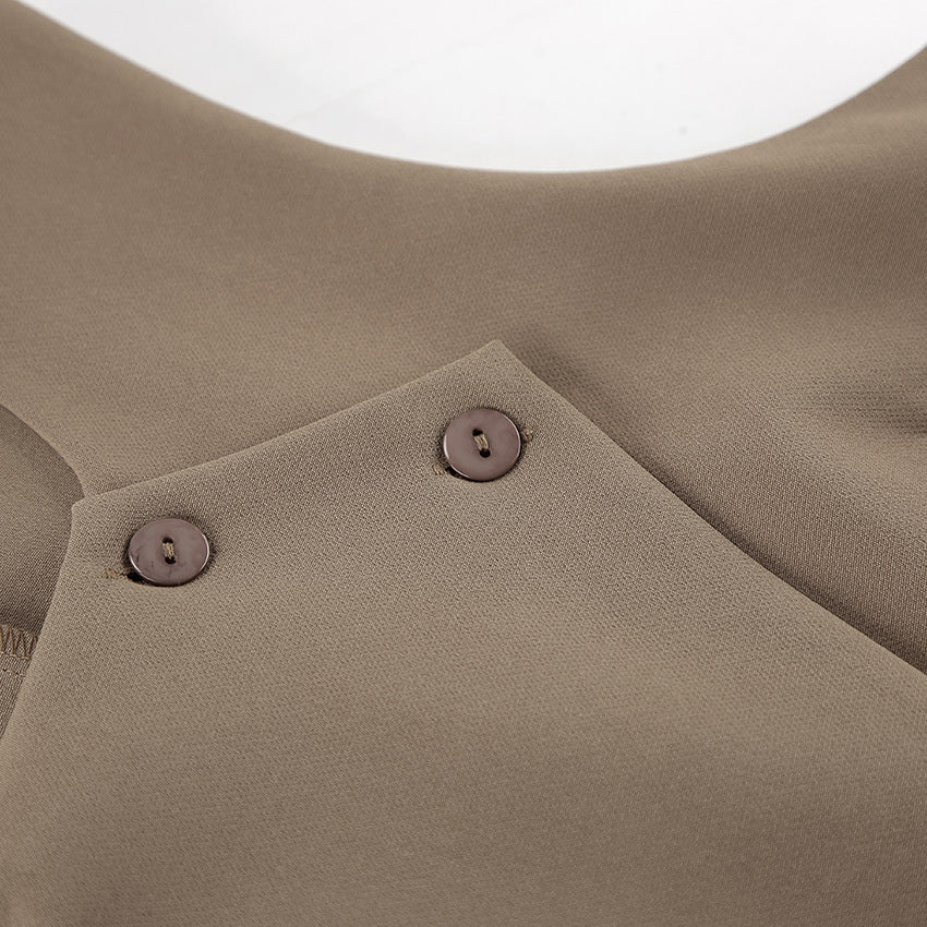 Close-up of a brown sleeveless tailored vest with buttons on a light background