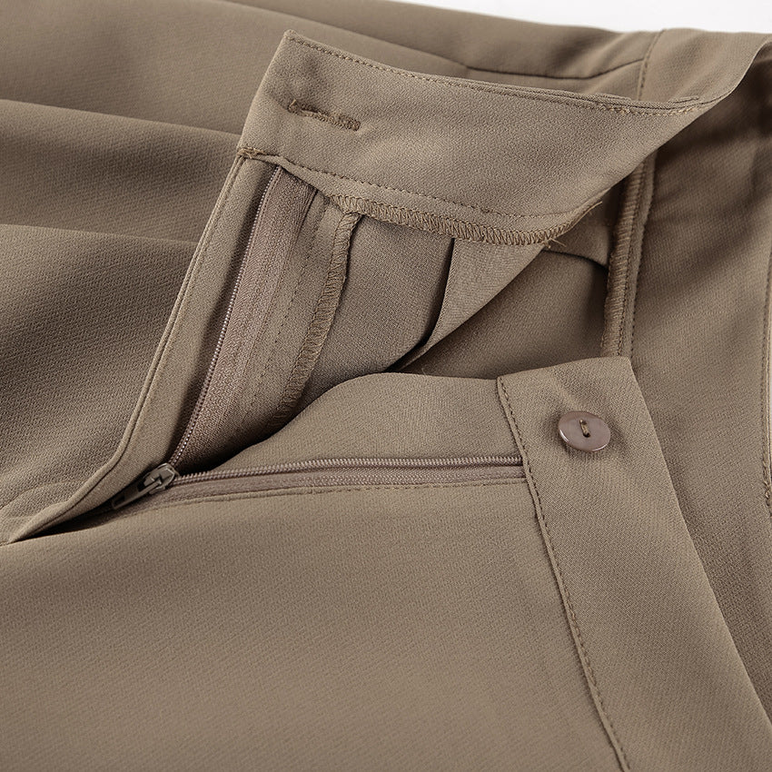 Close-up of brown two piece pant set  with zipper and button details