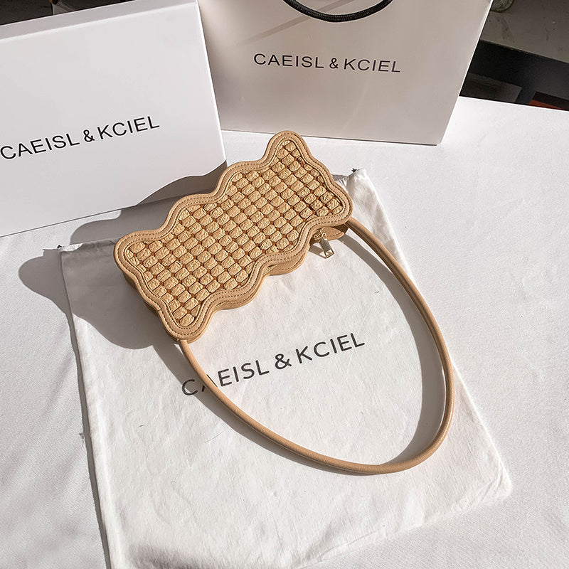 Beige woven headband on a white surface with 'CAEISL & KCIEL' branding.