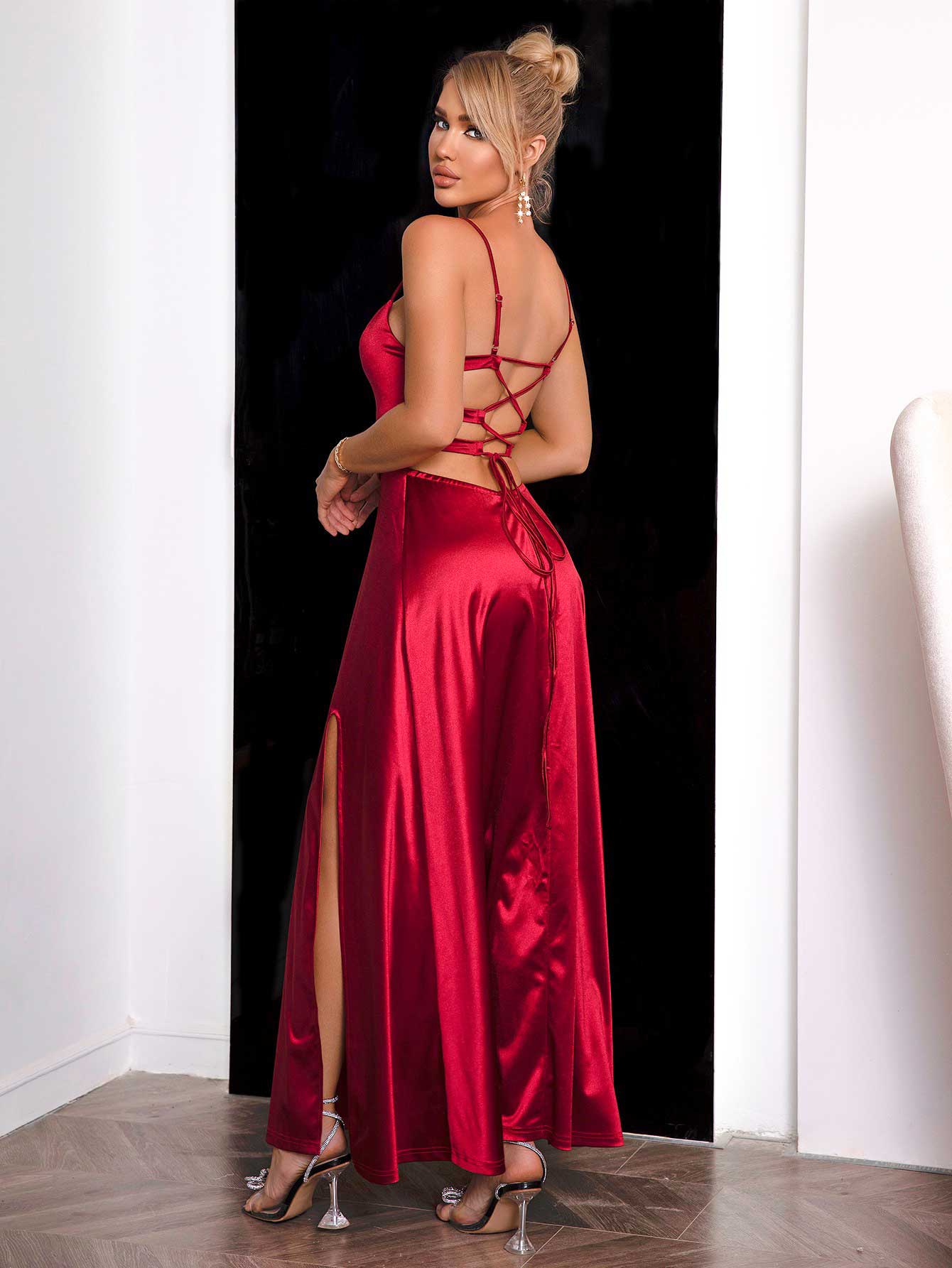Open lace-up back detail of sultry red maxi dress on a model 