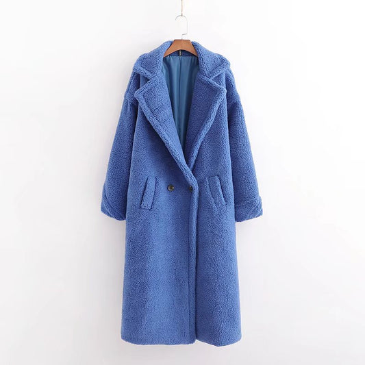 A long blue teddy plush coat with long sleeves, front buttons and pockets, displayed on a hanger against a white background.