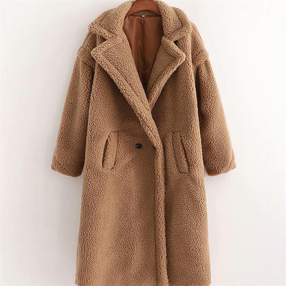 A long brown plush teddy coat with long sleeves, front buttons and pockets, displayed on a hanger against a white background.