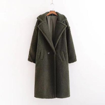 A long dark green teddy coat with long sleeves, front button and pockets, displayed on a hanger against a white background.