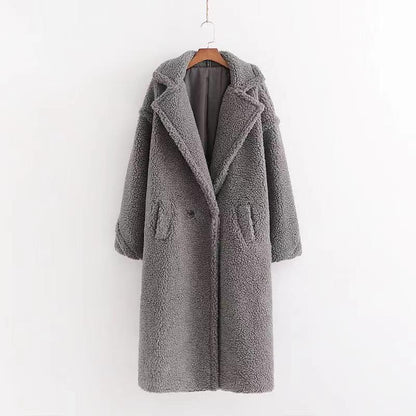 A long gray/grey plush teddy coat with long sleeves, front buttons and pockets displayed on a hanger against a white background.