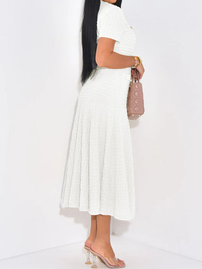 Side view of woman wearing a white ribbed bodycon stretch dress with gold buttons on a white background