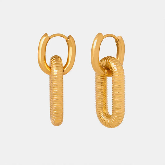 Pair of 18K gold plated dangle earrings with ribbed design on a light gray background