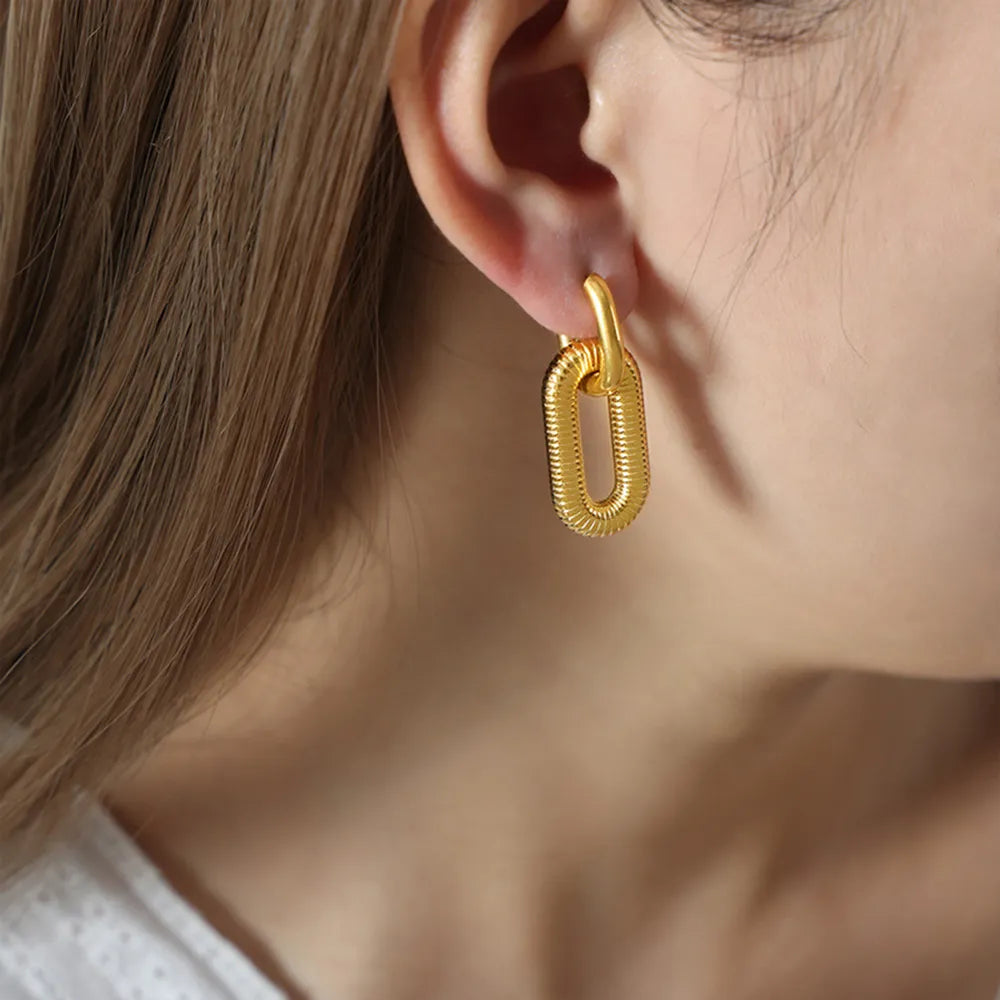 Woman wearing 18 K Gold dangle nickel free earrings