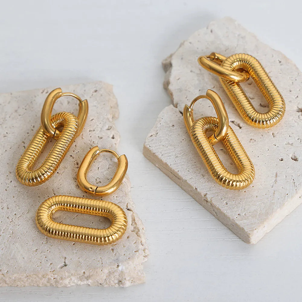 18K Gold plated hypoallergenic dangle earrings on a textured stone surface