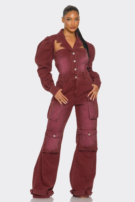 Woman wearing vintage-inspired utility burgundy jumpsuit with front button closure, with puff shoulders, cutouts, cargo flair front view