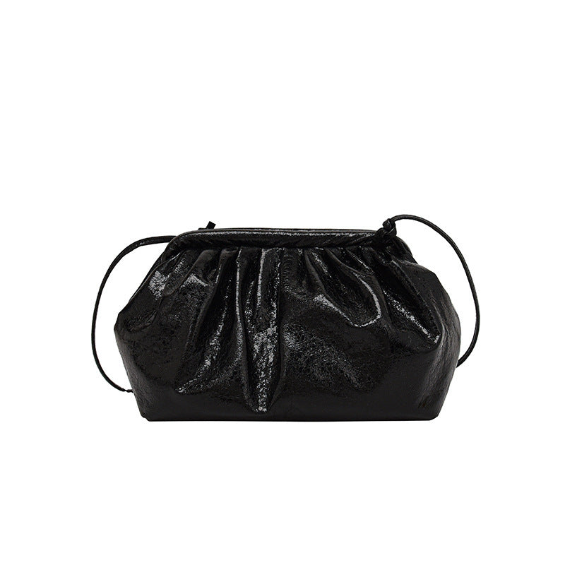 A metallic black colored  PU leather clip shell bag with detachable strap.