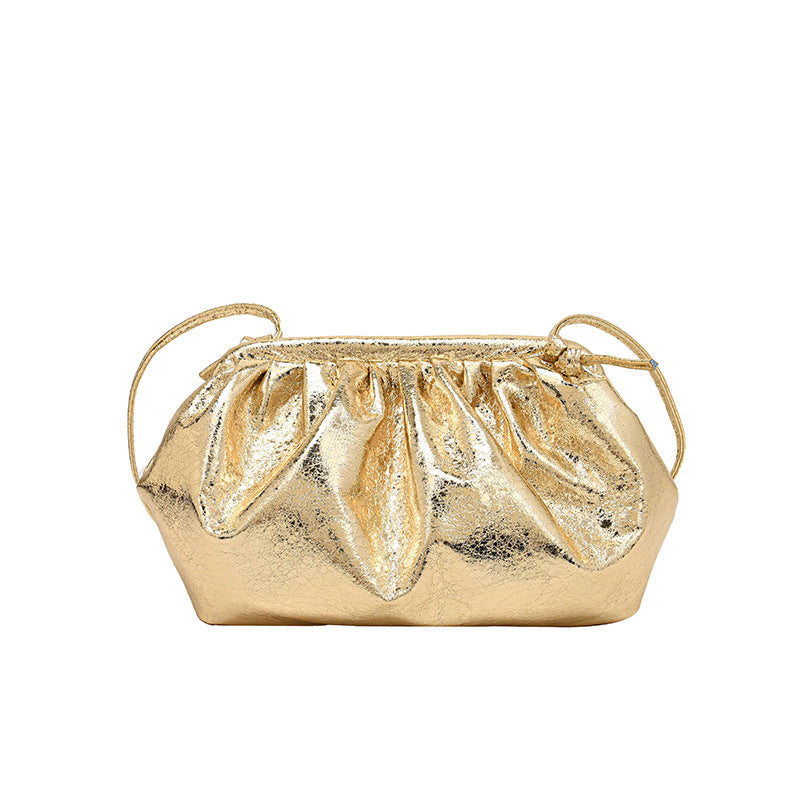 A metallic gold colored  PU leather clip shell bag with detachable strap.