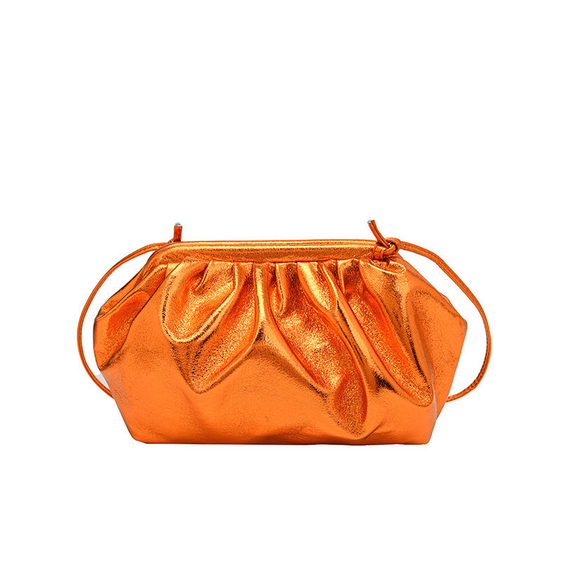 A metallic orange colored  PU leather clip shell bag with detachable strap.